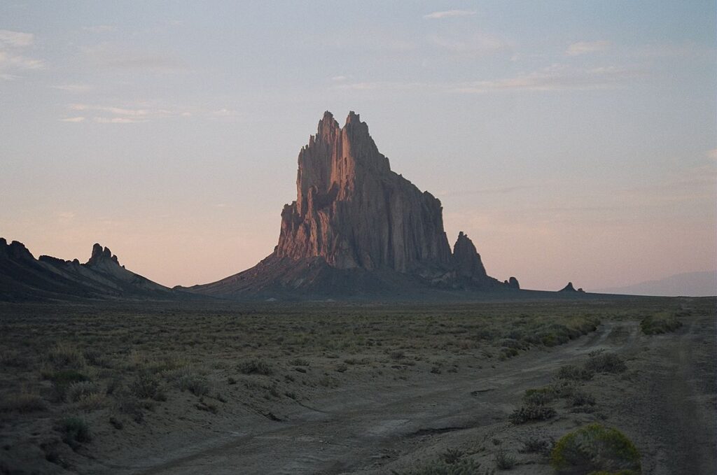 A large rock formation in the middle of nowhere.