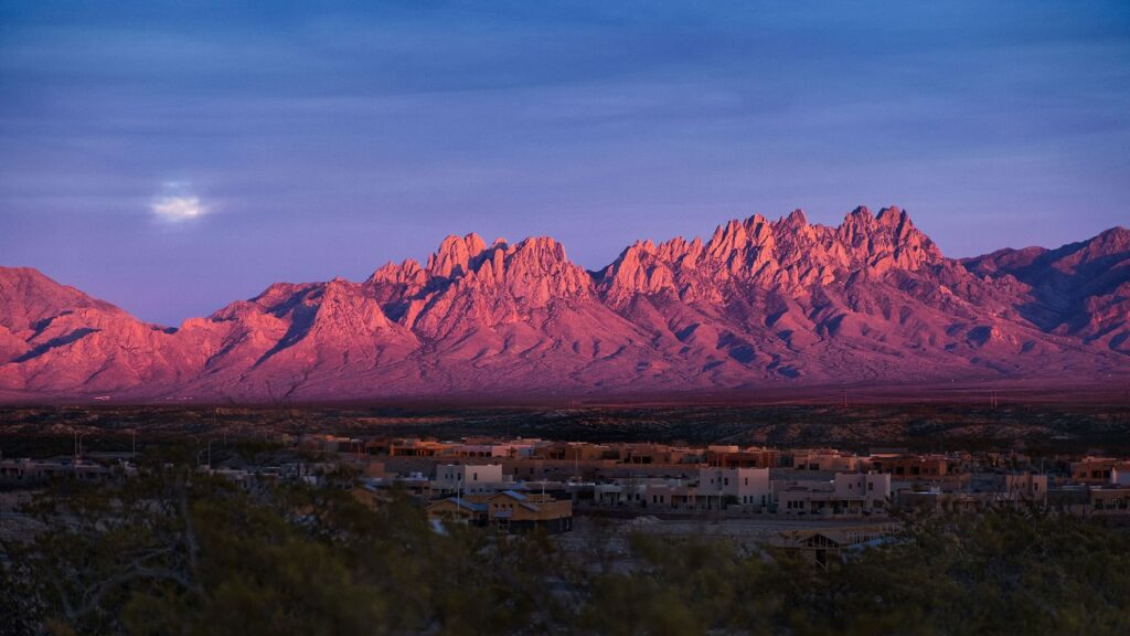 A view of the mountains at sunset from afar.