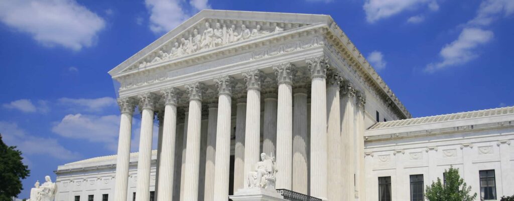 A close up of the front of a building with columns